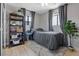 Cozy bedroom with a gray bed, wood shelving, and natural light at 4981 E Pawnee Pl, Pahrump, NV 89061