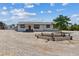 Charming single-story home with a welcoming front porch and desert landscaping at 4981 E Pawnee Pl, Pahrump, NV 89061