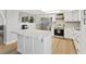 Modern kitchen with stainless steel appliances, white cabinets, and a spacious island, creating a sleek culinary space at 4981 E Pawnee Pl, Pahrump, NV 89061