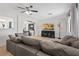 Comfortable living room featuring a large sectional couch, TV, and seamless access to the dining and kitchen area at 4981 E Pawnee Pl, Pahrump, NV 89061
