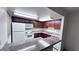 Functional kitchen with granite countertops, wood cabinets, and white appliances at 5251 Indian River Dr # 271, Las Vegas, NV 89103