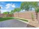 Backyard with a brick wall, rock landscaping, and artificial grass at 5653 Mount Athos St, North Las Vegas, NV 89031