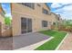 Backyard with sliding glass door, artificial grass, and rock landscaping at 5653 Mount Athos St, North Las Vegas, NV 89031