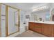 Bathroom with a tub, shower, and a double sink vanity with updated lighting at 5653 Mount Athos St, North Las Vegas, NV 89031