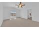 Bright bedroom featuring neutral carpet, ceiling fan, and a window with neighborhood views at 5653 Mount Athos St, North Las Vegas, NV 89031