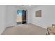 Bedroom with neutral carpet, sliding glass doors leading to the backyard, and simple decor at 5653 Mount Athos St, North Las Vegas, NV 89031