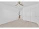 Bright bedroom featuring neutral carpet, ceiling fan, and closet with mirrored doors at 5653 Mount Athos St, North Las Vegas, NV 89031