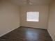 An empty bedroom with wood-look flooring and a window for natural light at 5751 E Hacienda Ave # 137, Las Vegas, NV 89122