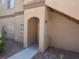 Inviting front entrance of a home with an arched doorway and desert landscaping at 5751 E Hacienda Ave # 137, Las Vegas, NV 89122