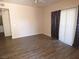 Spacious living room featuring wood-look tile flooring and sliding glass doors at 5751 E Hacienda Ave # 137, Las Vegas, NV 89122