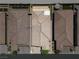 Aerial view of terracotta tile roofs, manicured lawns, and inviting outdoor spaces between attached single Gathering homes at 5936 Bruselas St, Las Vegas, NV 89113
