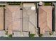 Aerial view of terracotta tile roofs, manicured lawns, and inviting outdoor spaces between attached single Gathering homes at 5936 Bruselas St, Las Vegas, NV 89113