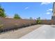 Spacious backyard featuring a large paved area, low maintenance landscaping, and privacy wall at 5936 Bruselas St, Las Vegas, NV 89113