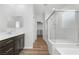 Bathroom featuring double sinks, a glass-enclosed shower, and access to a walk-in closet at 5936 Bruselas St, Las Vegas, NV 89113