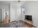 Bedroom with a couch, ceiling fan, and a TV set on a table at 5936 Bruselas St, Las Vegas, NV 89113