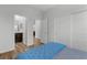 Bright bedroom featuring wood floors, a closet and bathroom access at 5936 Bruselas St, Las Vegas, NV 89113