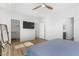 Bedroom view features a TV, closet, and bathroom entrance, highlighted by wood floors and neutral tones at 5936 Bruselas St, Las Vegas, NV 89113