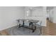 A bright dining area features a decorative rug and seating for six at 5936 Bruselas St, Las Vegas, NV 89113