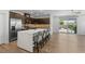 Spacious kitchen with stainless steel appliances and a bar with stools at 5936 Bruselas St, Las Vegas, NV 89113