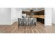 Kitchen with marble countertops, bar stools, and wood floors at 5936 Bruselas St, Las Vegas, NV 89113