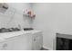 Laundry room with a washer, a dryer, and storage shelving at 5936 Bruselas St, Las Vegas, NV 89113