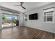 Bright living area with wood flooring and sliding glass doors to the outdoor patio at 5936 Bruselas St, Las Vegas, NV 89113