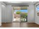 Bright living area with wood flooring and sliding glass doors to the outdoor patio at 5936 Bruselas St, Las Vegas, NV 89113