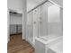 Sleek glass-enclosed shower and tub in the bathroom, complemented by a view of the closet at 5936 Bruselas St, Las Vegas, NV 89113