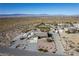 Aerial view of property featuring the house, landscaping, sheds, and desert surroundings at 5950 Mojave St, Pahrump, NV 89061