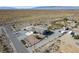 Aerial view showcases the house, desert landscape, and surrounding neighborhood at 5950 Mojave St, Pahrump, NV 89061