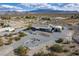 Aerial view featuring desert landscaping, gravel yard, detached garage, patio, and mountain views at 5950 Mojave St, Pahrump, NV 89061