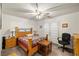 Bedroom with light wood furniture, ceiling fan, neutral carpet and walls, and double doors leading to exterior at 5950 Mojave St, Pahrump, NV 89061