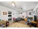 Bright bedroom featuring twin beds, ceiling fans, and an interior doorway to a garage at 5950 Mojave St, Pahrump, NV 89061