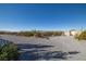 Gravel driveway and yard with desert surroundings and storage shed at 5950 Mojave St, Pahrump, NV 89061