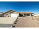 Charming single-story home with a two-car garage, desert landscaping, and covered front porch at 5950 Mojave St, Pahrump, NV 89061