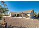 A single story home with desert landscaping and a covered porch at 5950 Mojave St, Pahrump, NV 89061