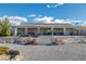 Expansive single-story home with a long covered porch and steps, surrounded by a low maintenance desert landscape at 5950 Mojave St, Pahrump, NV 89061