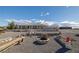 Wide shot of the house, showing the fire pit, gravel yard, and low maintenance landscaping at 5950 Mojave St, Pahrump, NV 89061