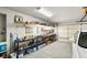 Spacious garage featuring storage shelving and a parked white car at 5950 Mojave St, Pahrump, NV 89061
