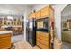 Kitchen with appliances, wooden cabinets, and adjacent dining room at 5950 Mojave St, Pahrump, NV 89061