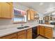 Bright kitchen features natural wood cabinets and a view of the outside at 5950 Mojave St, Pahrump, NV 89061