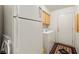 Laundry room with washer, dryer, white refrigerator and door leading outside, and built-in cabinets at 5950 Mojave St, Pahrump, NV 89061