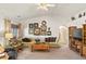 This comfortable living room features an oversized couch, wall decor, and a ceiling fan at 5950 Mojave St, Pahrump, NV 89061