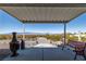 Covered patio showcasing outdoor seating, offering scenic views of the surrounding desert and distant mountains at 5950 Mojave St, Pahrump, NV 89061