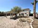 Expansive backyard featuring desert landscaping, mature trees, and shaded pergola area at 6571 Abalone Shell Ct, Las Vegas, NV 89139