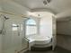 Well-lit bathroom boasts a luxurious soaking tub with elegant fixtures, and glass shower with stylish accents at 6571 Abalone Shell Ct, Las Vegas, NV 89139
