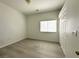 Bedroom featuring ample natural light and sleek floors, providing a bright and modern appeal at 6571 Abalone Shell Ct, Las Vegas, NV 89139