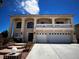 Two-story home featuring arched columns, a second story balcony, and a spacious three car garage at 6571 Abalone Shell Ct, Las Vegas, NV 89139