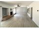 Open floor plan of a bright living room with sleek floors, a cozy fireplace and a ceiling fan at 6571 Abalone Shell Ct, Las Vegas, NV 89139