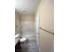 A well-lit bathroom features a shower over tub and stylish gray tile flooring at 6800 E Lake Mead Blvd # 2024, Las Vegas, NV 89156